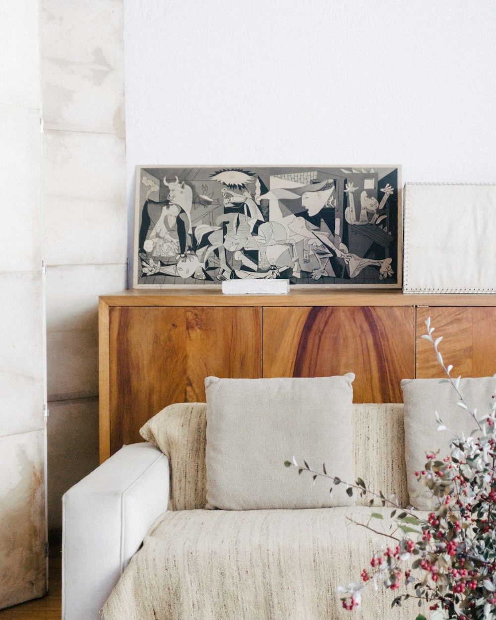 A bright seating area with a wood sideboard